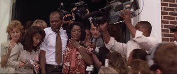 Movie still from “A Time to Kill” (1996), directed by Joel Schumacher – A group of people standing around a crowd of people; Medium shot, Low angle