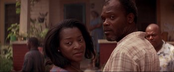 Movie still from “A Time to Kill” (1996), directed by Joel Schumacher – A man and a woman standing next to each other in a room; Close Up shot, Over the shoulder angle