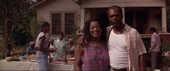 Movie still from “A Time to Kill” (1996), directed by Joel Schumacher – A man and a woman standing in front of a table; Medium shot, Low angle