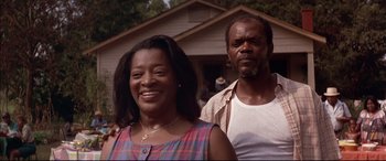 Movie still from “A Time to Kill” (1996), directed by Joel Schumacher – A man and a woman standing in front of a house; Close Up shot, Low angle