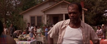 Movie still from “A Time to Kill” (1996), directed by Joel Schumacher – A man standing in front of a group of people; Close Up shot, Low angle