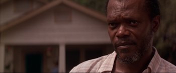 Movie still from “A Time to Kill” (1996), directed by Joel Schumacher – A man's face in front of a house; Close Up shot, Over the shoulder angle