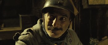 Movie still from “A Very Long Engagement” (2004), directed by Jean-Pierre Jeunet – A person wearing a motorcycle helmet; Close Up shot, Over the shoulder angle