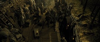 Movie still from “A Very Long Engagement” (2004), directed by Jean-Pierre Jeunet – A group of men standing next to each other on a dock; Wide shot, High angle