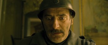 Movie still from “A Very Long Engagement” (2004), directed by Jean-Pierre Jeunet – A person wearing a helmet; Close Up shot, Low angle