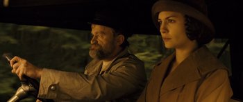 Movie still from “A Very Long Engagement” (2004), directed by Jean-Pierre Jeunet – A man and a woman are standing under an umbrella in the dark; Close Up shot, Low angle