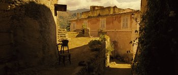 Movie still from “A Very Long Engagement” (2004), directed by Jean-Pierre Jeunet – An empty chair in the middle of an outdoor area; Extreme Wide shot, High angle