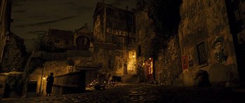 Movie still from “A Very Long Engagement” (2004), directed by Jean-Pierre Jeunet – An old city at night with a horse and carriage; Extreme Wide shot, High angle
