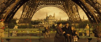 Movie still from “A Very Long Engagement” (2004), directed by Jean-Pierre Jeunet – A group of people sitting on a bench in front of an ornate building; Wide shot, Low angle