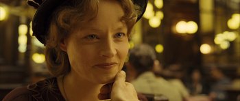 Movie still from “A Very Long Engagement” (2004), directed by Jean-Pierre Jeunet – An older woman wearing a black hat and looking at the camera; Close Up shot, Over the shoulder angle