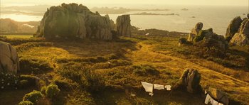 Movie still from “A Very Long Engagement” (2004), directed by Jean-Pierre Jeunet – An image of an outdoor setting with a view of the ocean; Extreme Wide shot, High angle