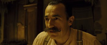 Movie still from “A Very Long Engagement” (2004), directed by Jean-Pierre Jeunet – A person with a mustache; Close Up shot, Low angle