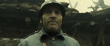 Movie still from “A Very Long Engagement” (2004), directed by Jean-Pierre Jeunet – A man in a military uniform wearing a helmet; Close Up shot, Low angle