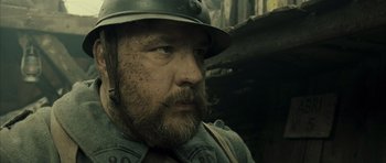 Movie still from “A Very Long Engagement” (2004), directed by Jean-Pierre Jeunet – A person wearing a helmet; Close Up shot, Low angle