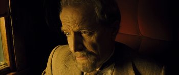Movie still from “A Very Long Engagement” (2004), directed by Jean-Pierre Jeunet – An older man with a beard and a mustache; Close Up shot, High angle