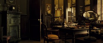 Movie still from “A Very Long Engagement” (2004), directed by Jean-Pierre Jeunet – A room filled with furniture and a large window; Wide shot, High angle