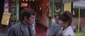 Movie still from “A Woman Is a Woman” (1961), directed by Jean-Luc Godard – A man and a woman are talking to each other; Medium shot, Over the shoulder angle