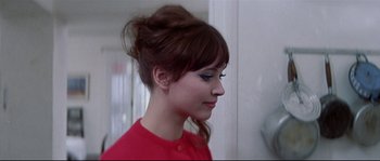 Movie still from “A Woman Is a Woman” (1961), directed by Jean-Luc Godard – A person wearing a red shirt; Close Up shot, Over the shoulder angle