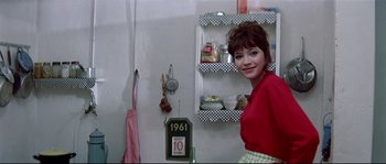 Movie still from “A Woman Is a Woman” (1961), directed by Jean-Luc Godard – A woman standing in front of an open refrigerator; Medium shot, Low angle
