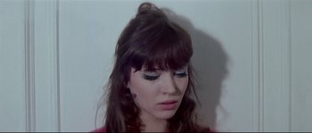 Movie still from “A Woman Is a Woman” (1961), directed by Jean-Luc Godard – A person with long brown hair; Close Up shot, High angle