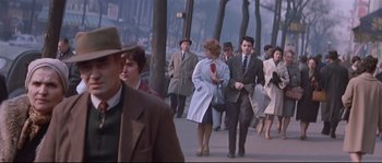 Movie still from “A Woman Is a Woman” (1961), directed by Jean-Luc Godard – A crowd of people walking down a sidewalk; Medium shot, Low angle