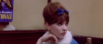 Movie still from “A Woman Is a Woman” (1961), directed by Jean-Luc Godard – A woman with a blue bow in her hair; Close Up shot, Low angle