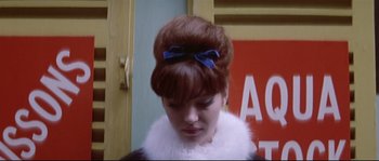 Movie still from “A Woman Is a Woman” (1961), directed by Jean-Luc Godard – A woman with a blue bow in her hair; Close Up shot, Low angle