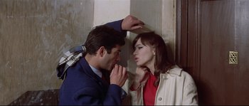 Movie still from “A Woman Is a Woman” (1961), directed by Jean-Luc Godard – A man and a woman face each other in a corner; Medium shot, High angle