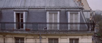 Movie still from “A Woman Is a Woman” (1961), directed by Jean-Luc Godard – A cat sitting on a balcony of a building; Extreme Wide shot, Low angle