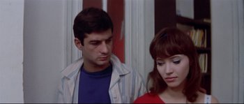 Movie still from “A Woman Is a Woman” (1961), directed by Jean-Luc Godard – A man and a woman standing next to each other; Close Up shot, Over the shoulder angle