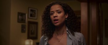 Movie still from “A Wrinkle in Time” (2018), directed by Ava DuVernay – A beautiful woman with curly hair standing in a room; Close Up shot, Over the shoulder angle