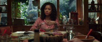 Movie still from “A Wrinkle in Time” (2018), directed by Ava DuVernay – A woman sitting at a table with a bowl of food; Medium shot, Over the shoulder angle
