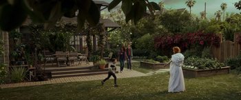 Movie still from “A Wrinkle in Time” (2018), directed by Ava DuVernay – Two women and a child are in a backyard; Wide shot, Over the shoulder angle
