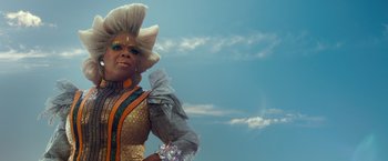Movie still from “A Wrinkle in Time” (2018), directed by Ava DuVernay – A woman in a costume standing in front of a blue sky; Close Up shot, Over the shoulder angle