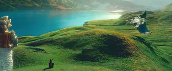 Movie still from “A Wrinkle in Time” (2018), directed by Ava DuVernay – A green field with a lake in the background; Extreme Wide shot, High angle