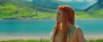 Movie still from “A Wrinkle in Time” (2018), directed by Ava DuVernay – A woman with long red hair standing next to a body of water; Medium shot, Low angle