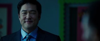 Movie still from “A Wrinkle in Time” (2018), directed by Ava DuVernay – A person wearing a suit and tie; Close Up shot, Over the shoulder angle