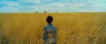 Movie still from “A Wrinkle in Time” (2018), directed by Ava DuVernay – A boy standing in the middle of an open field; Extreme Wide shot, High angle