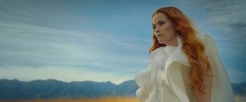 Movie still from “A Wrinkle in Time” (2018), directed by Ava DuVernay – A woman with red hair standing in front of mountains; Medium shot, Low angle