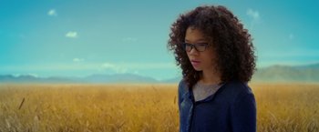 Movie still from “A Wrinkle in Time” (2018), directed by Ava DuVernay – A woman standing in front of a wheat field; Medium shot, Low angle