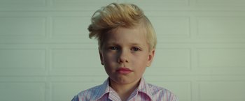 Movie still from “A Wrinkle in Time” (2018), directed by Ava DuVernay – A young boy with blonde hair wearing a pink and white checkered shirt; Close Up shot, Low angle