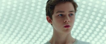 Movie still from “A Wrinkle in Time” (2018), directed by Ava DuVernay – A young boy with blue eyes stares into the distance; Close Up shot, Low angle