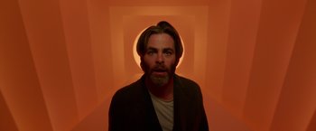 Movie still from “A Wrinkle in Time” (2018), directed by Ava DuVernay – A man with long hair and a beard stares into the camera; Medium shot, Low angle