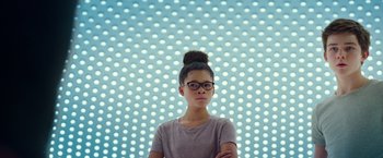 Movie still from “A Wrinkle in Time” (2018), directed by Ava DuVernay – A woman with glasses is standing in front of a wall of lights; Close Up shot, Low angle