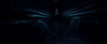 Movie still from “A Wrinkle in Time” (2018), directed by Ava DuVernay – A person standing in a dark room with their feet on the ground; Wide shot, Low angle