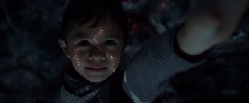Movie still from “A Wrinkle in Time” (2018), directed by Ava DuVernay – A little boy that is looking up at the camera; Close Up shot, Overhead angle