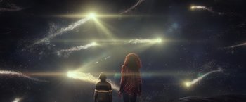 Movie still from “A Wrinkle in Time” (2018), directed by Ava DuVernay – Two people standing in front of a sky filled with smoke; Extreme Wide shot, Low angle