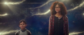 Movie still from “A Wrinkle in Time” (2018), directed by Ava DuVernay – Two young people standing next to each other in front of a sky background; Medium shot, Low angle