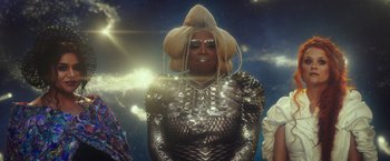 Movie still from “A Wrinkle in Time” (2018), directed by Ava DuVernay – A man in a silver outfit and a blonde wig; Medium shot, Low angle