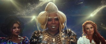 Movie still from “A Wrinkle in Time” (2018), directed by Ava DuVernay – A woman with blonde hair wearing a gold outfit; Close Up shot, Over the shoulder angle